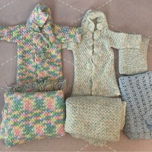 Homemade knitted baby coats and blankets